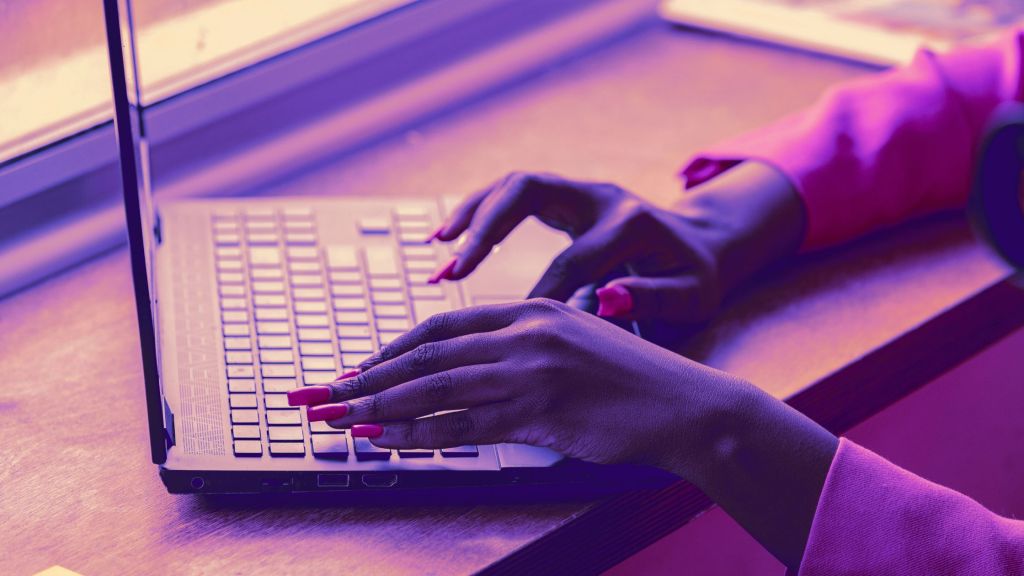Young woman typing on a computer